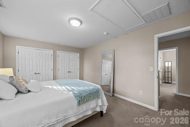 a bedroom with a bed and a mirror