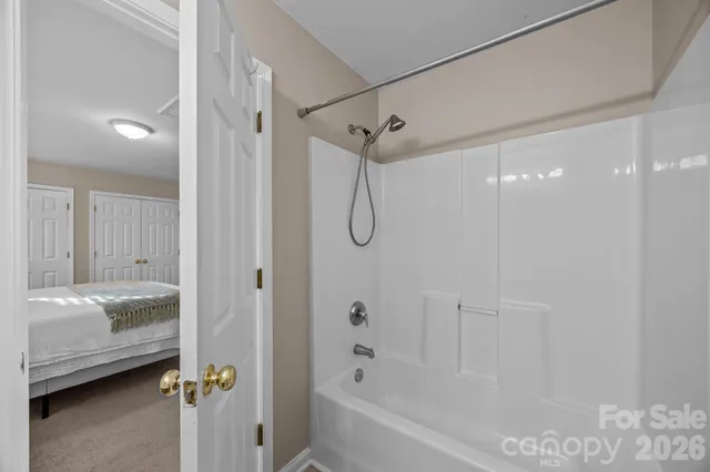 a bathroom that has a glass shower door
