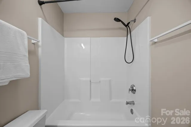 a bathroom with a bath tub with a shower