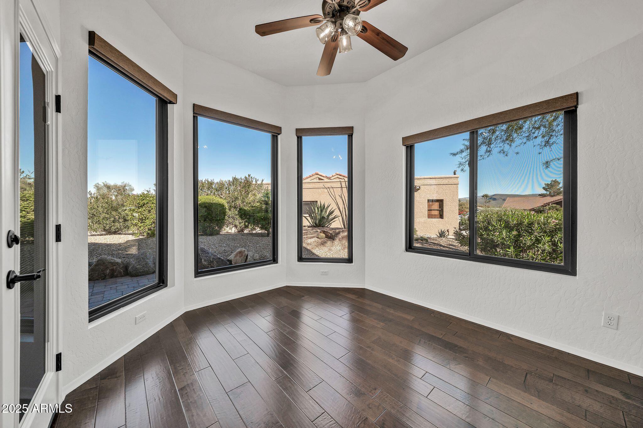 19002 East Alondra Way Rio Verde, AZ 85263 - Photo 13 of 62 a view of an empty room with wooden floor and a window