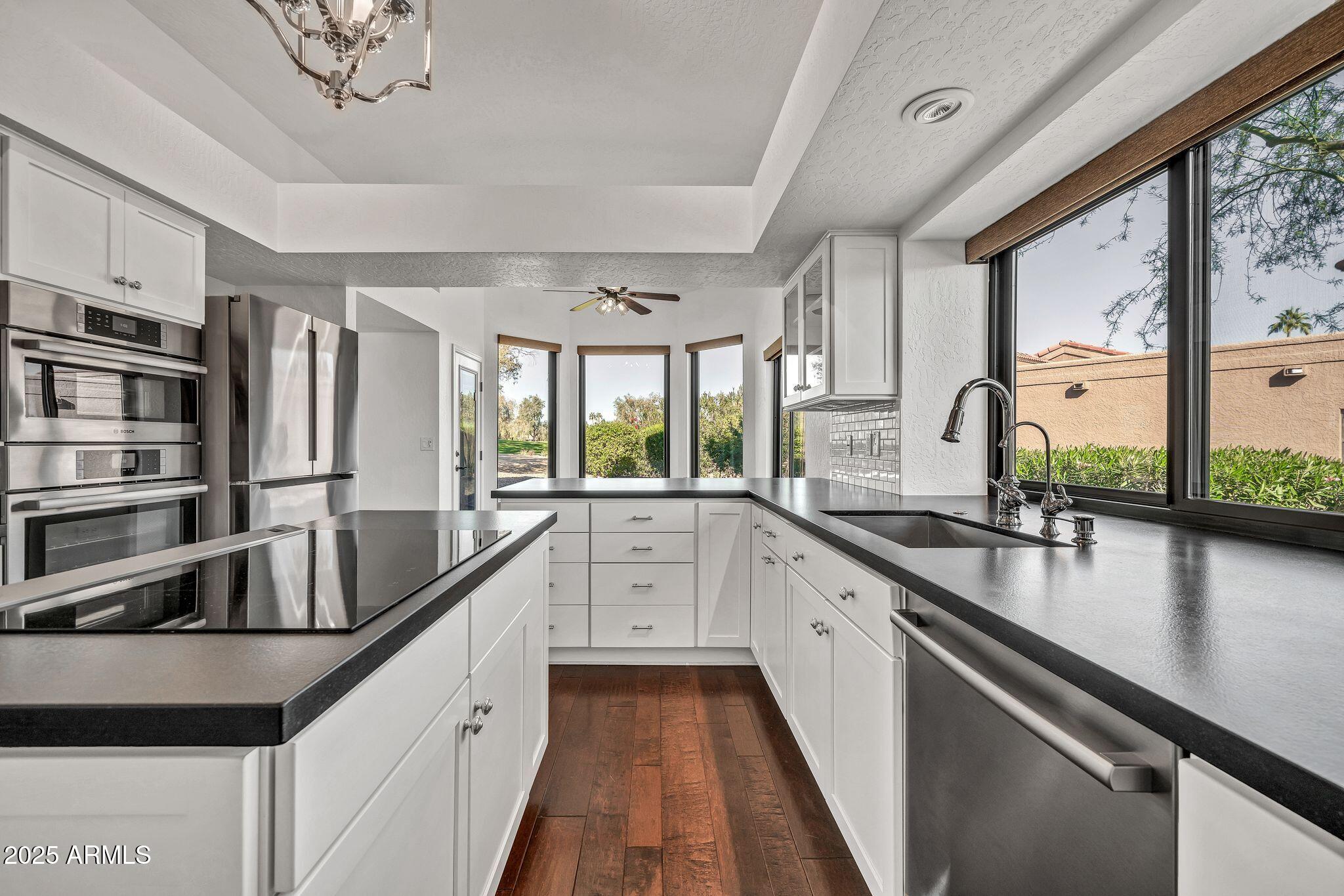 19002 East Alondra Way Rio Verde, AZ 85263 - Photo 25 of 62 a kitchen with stainless steel appliances granite countertop a sink a stove and a refrigerator