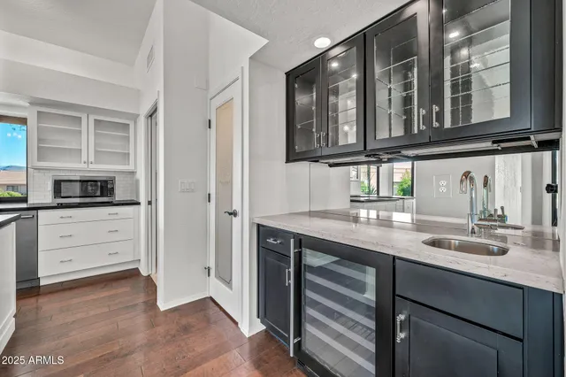 a kitchen with stainless steel appliances granite countertop a refrigerator and a sink