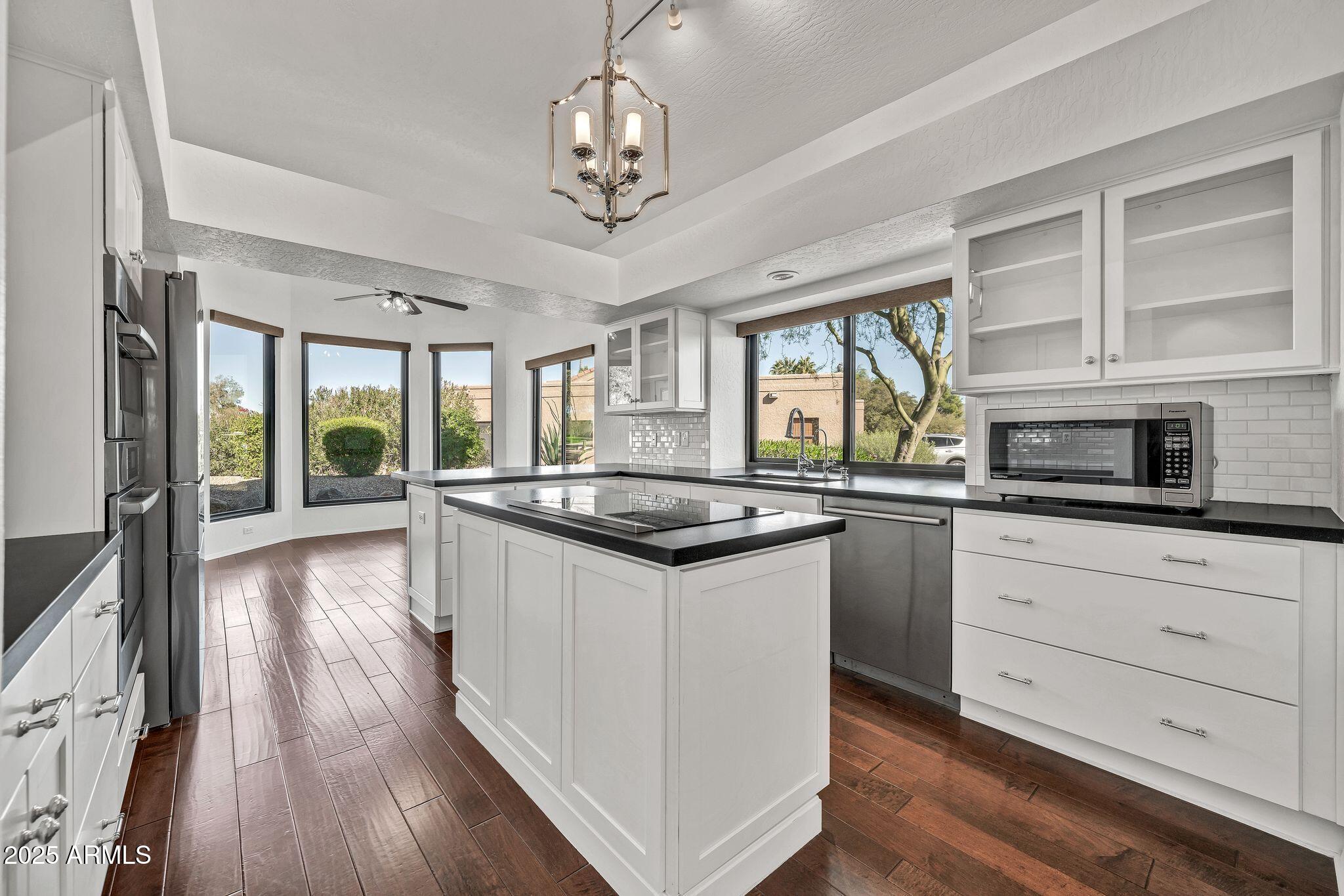 19002 East Alondra Way Rio Verde, AZ 85263 - Photo 28 of 62 a kitchen with stainless steel appliances granite countertop a stove and a view of living room