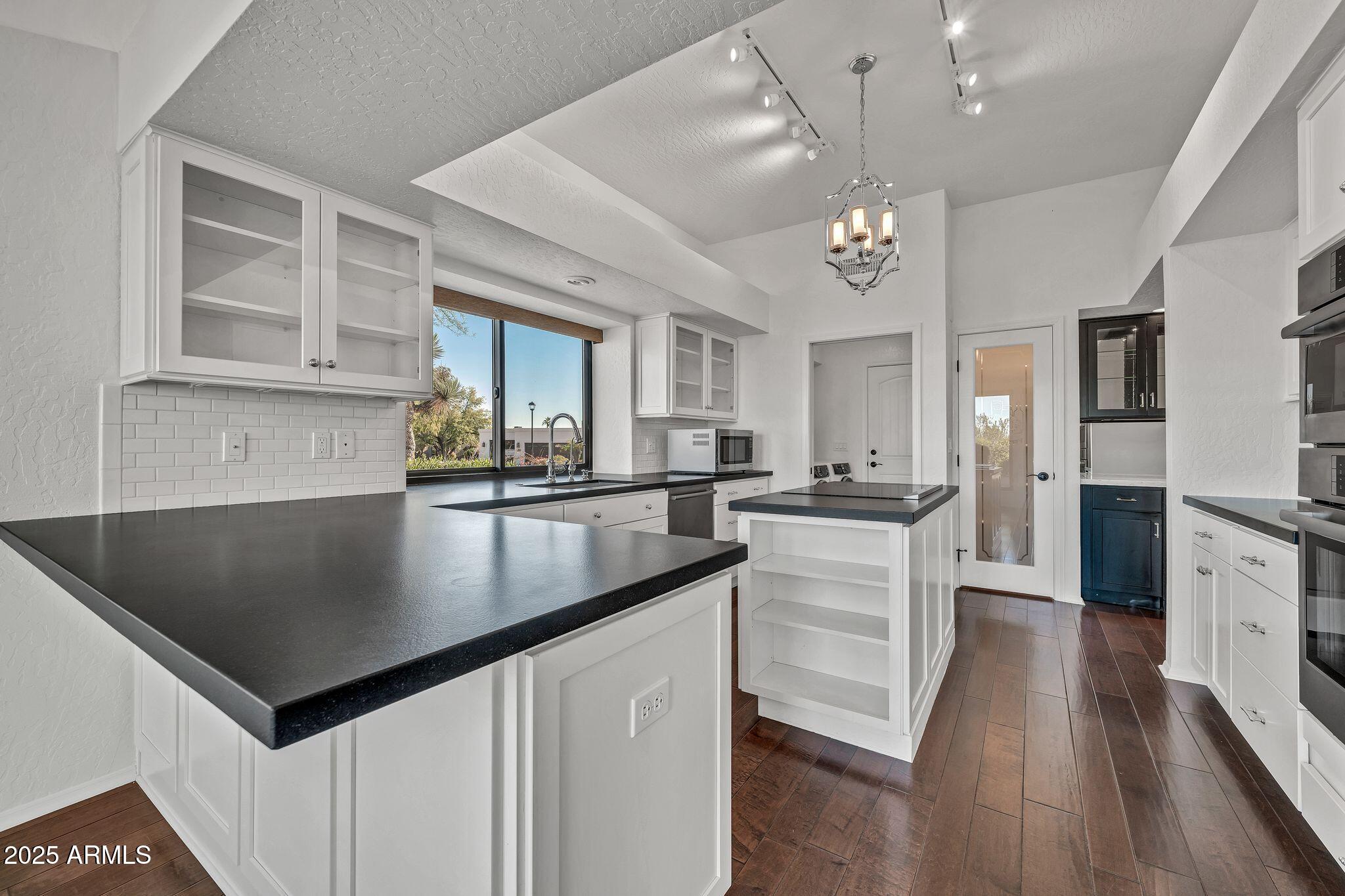 19002 East Alondra Way Rio Verde, AZ 85263 - Photo 29 of 62 a kitchen with granite countertop a sink a counter top space and stainless steel appliances