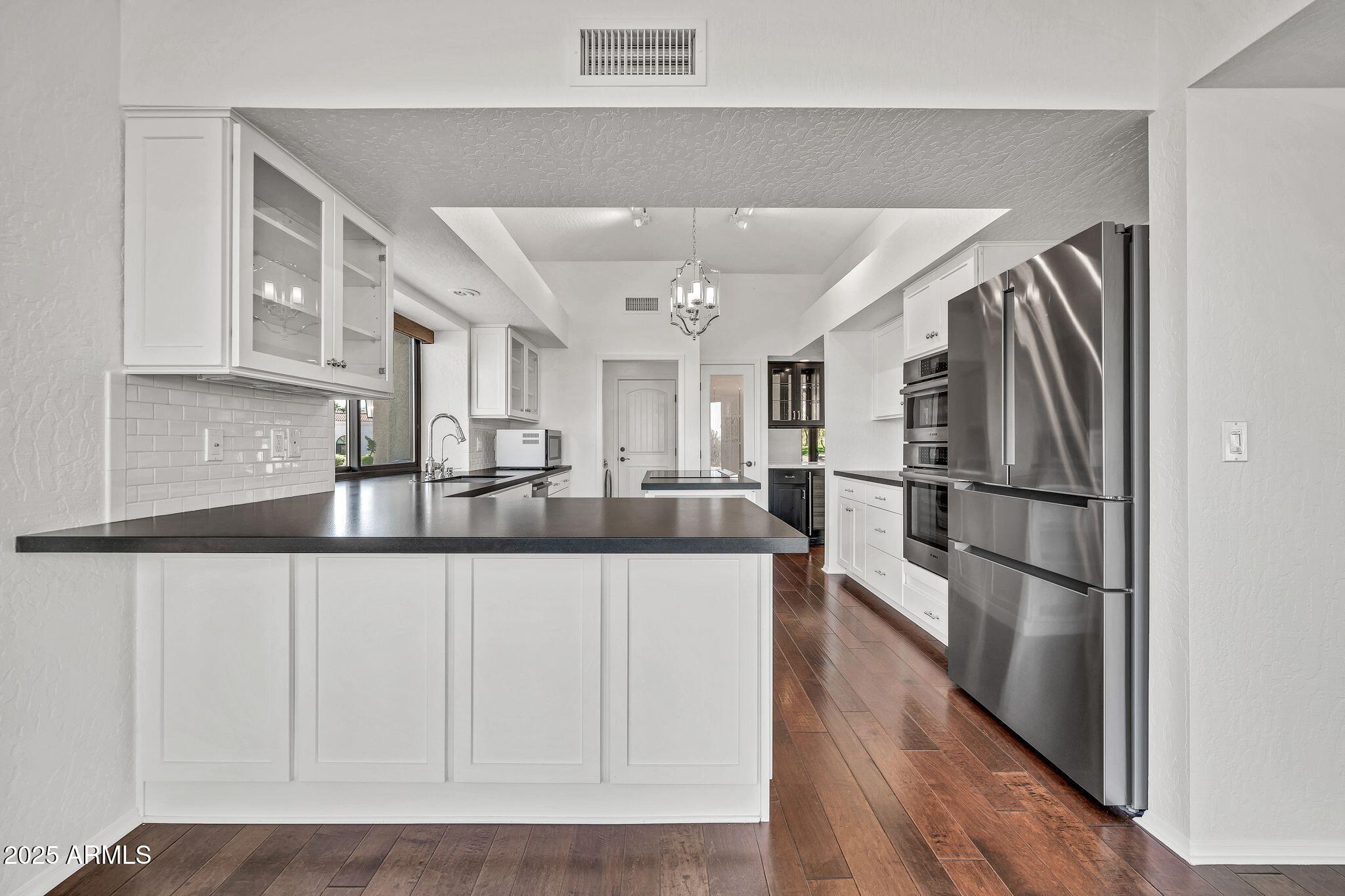 19002 East Alondra Way Rio Verde, AZ 85263 - Photo 30 of 62 a kitchen with stainless steel appliances granite countertop a refrigerator and a sink