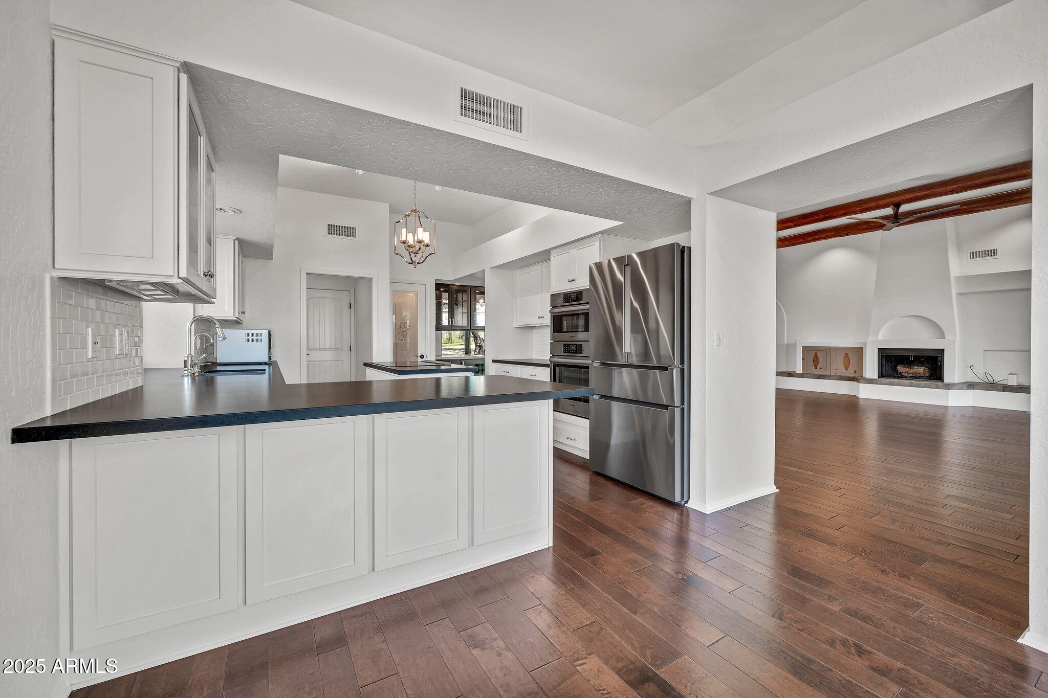 19002 East Alondra Way Rio Verde, AZ 85263 - Photo 31 of 62 a kitchen with stainless steel appliances granite countertop a refrigerator and a sink