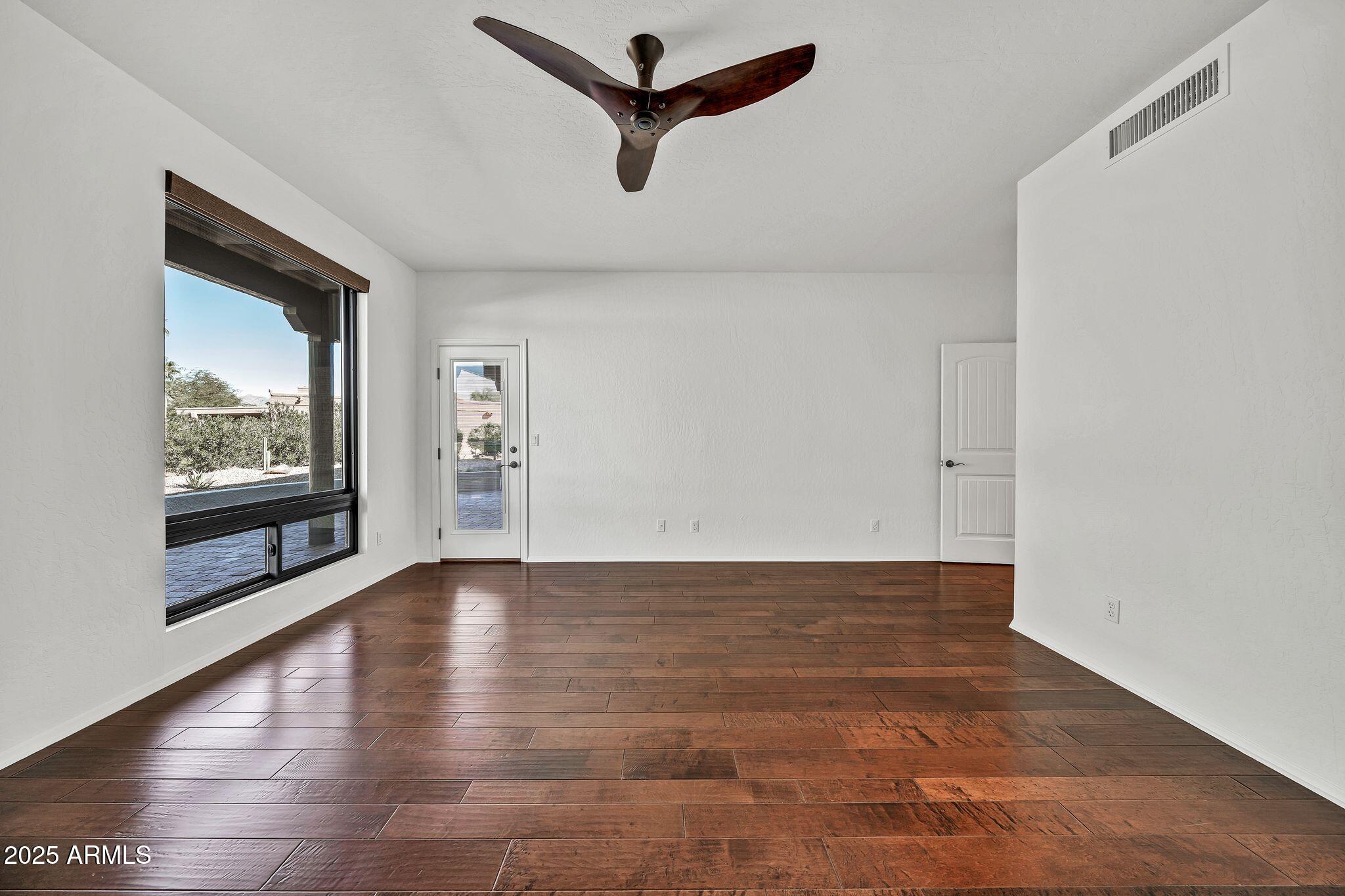 19002 East Alondra Way Rio Verde, AZ 85263 - Photo 32 of 62 a view of empty room with wooden floor and fan