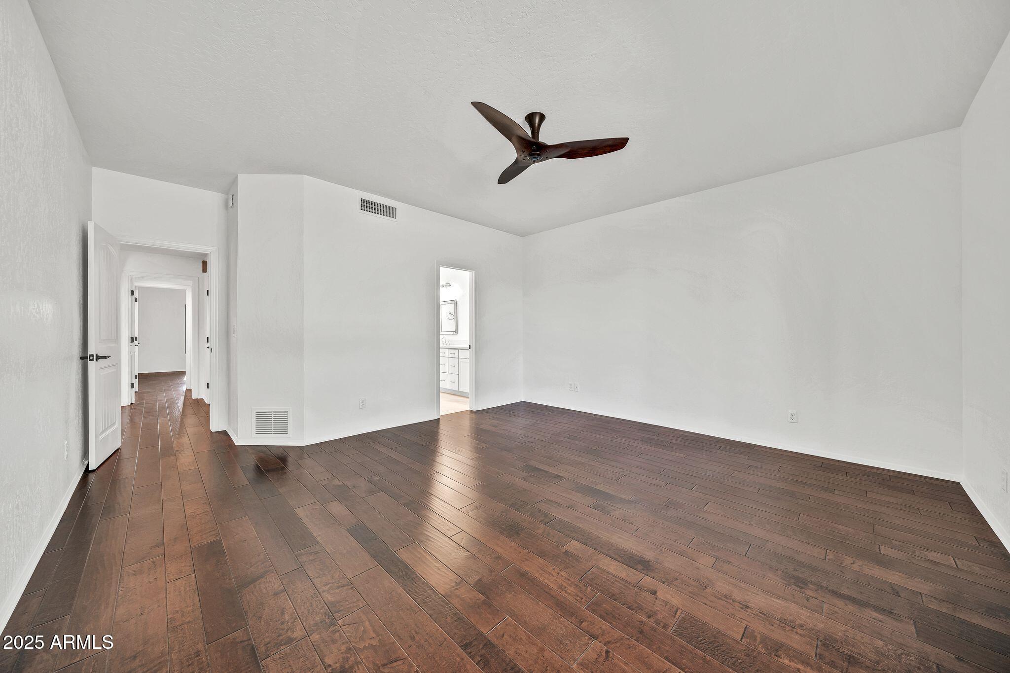 19002 East Alondra Way Rio Verde, AZ 85263 - Photo 35 of 62 a view of a livingroom with wooden floor and a ceiling fan