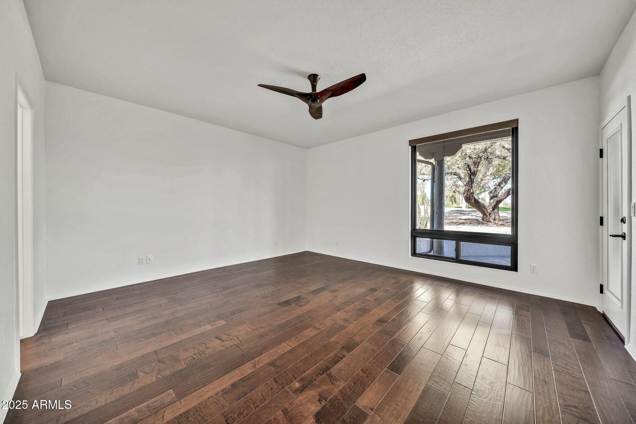 19002 East Alondra Way Rio Verde, AZ 85263 - Photo 36 of 62 an empty room with wooden floor and windows