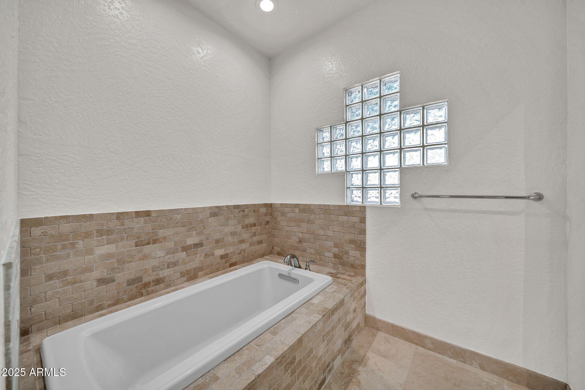 19002 East Alondra Way Rio Verde, AZ 85263 - Photo 40 of 62 a bath tub sitting in a bathroom next to a window