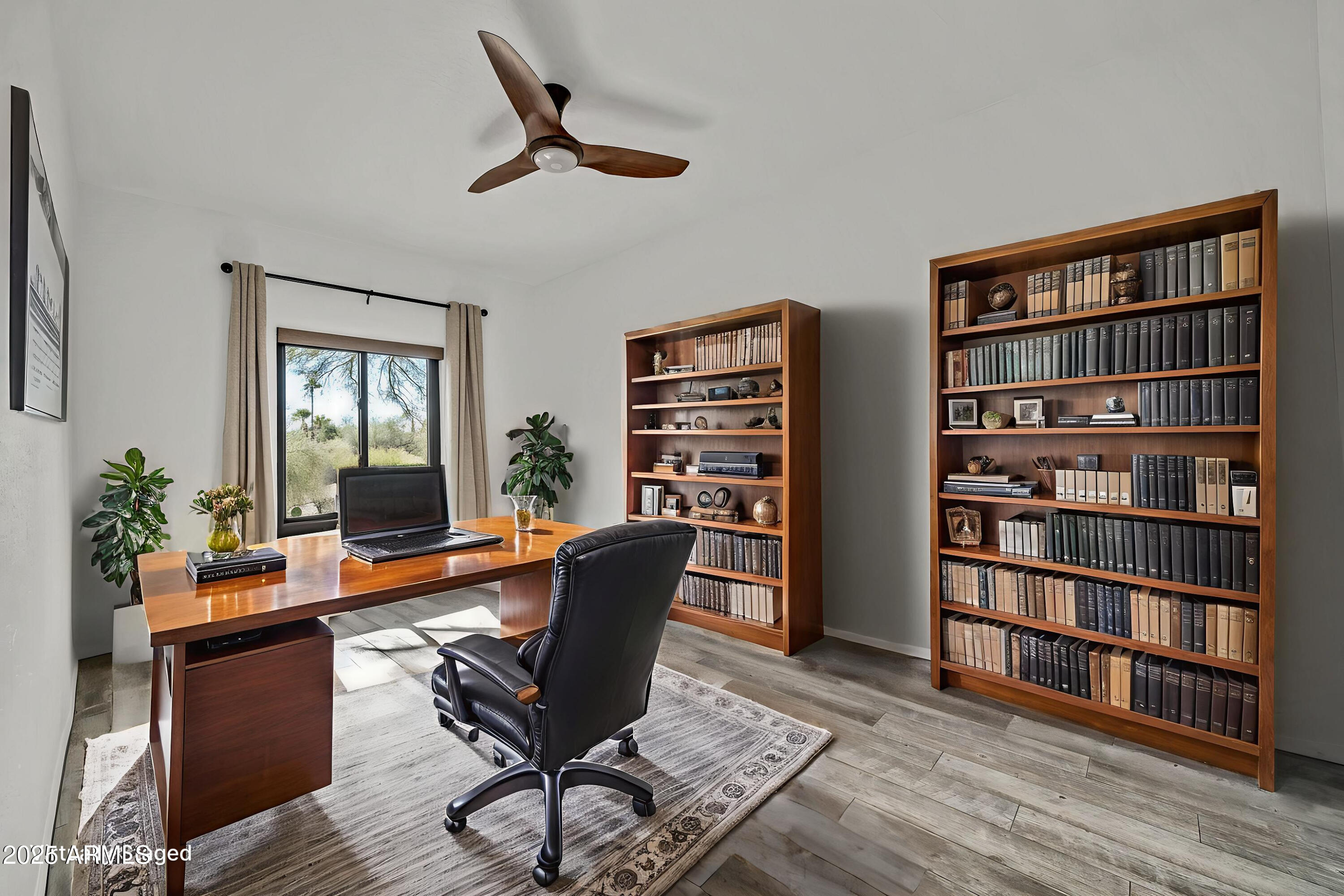 19002 East Alondra Way Rio Verde, AZ 85263 - Photo 45 of 62 a living room with furniture and a book shelf