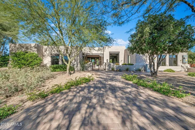 a view of a house with a yard and a garage