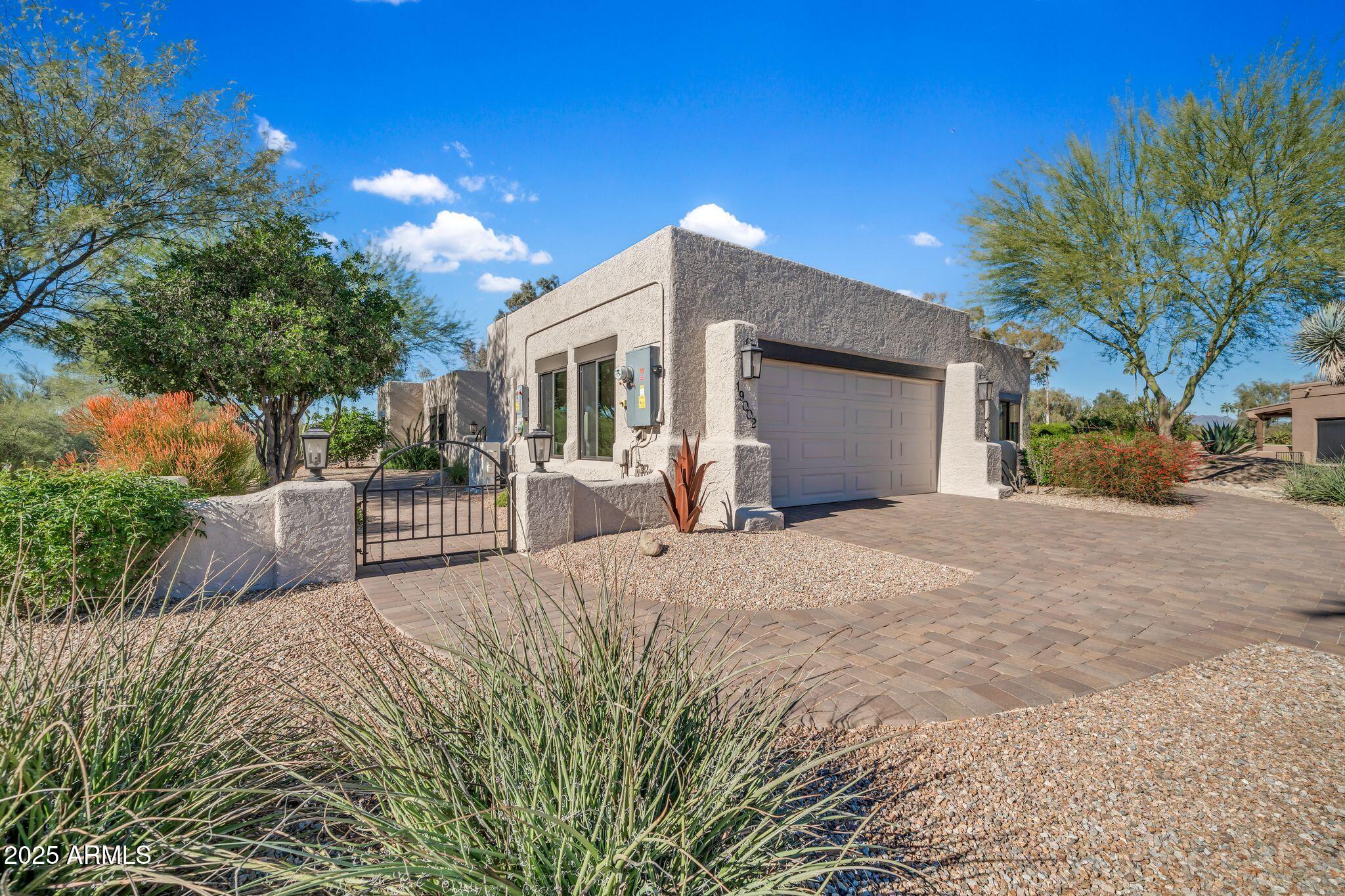 19002 East Alondra Way Rio Verde, AZ 85263 - Photo 9 of 62 a view of a house with a yard and a garage