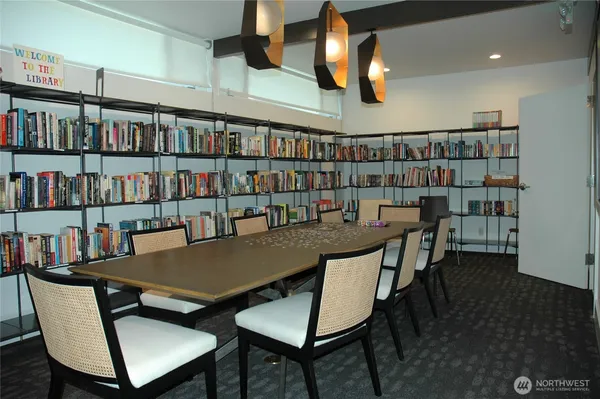 a view of a dining room with furniture and a book shelf