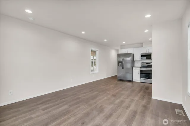 a view of kitchen with refrigerator and window