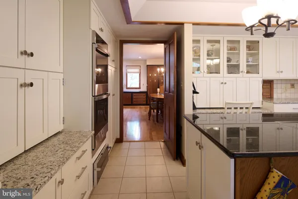 a spacious bedroom with a bed and wooden floor