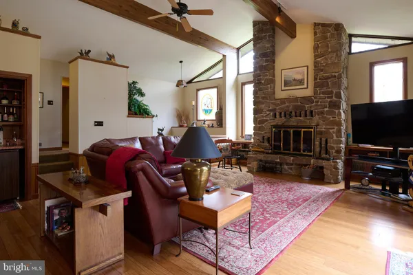 a living room with furniture and a book shelf