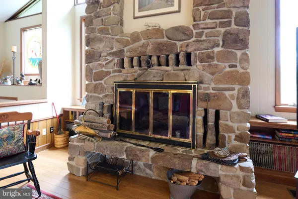 a living room with furniture a rug and a book shelf