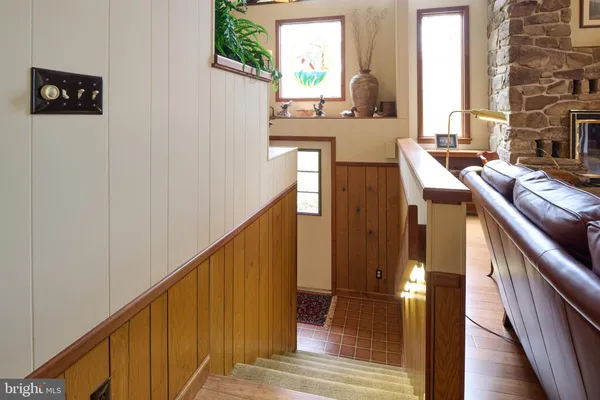 a bathroom with granite countertop a sink a mirror and a bathtub next to a window