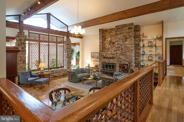 a kitchen with stainless steel appliances granite countertop a sink a counter top space and living room view