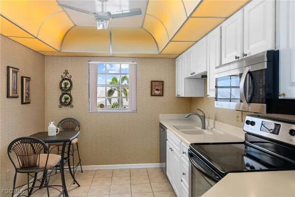 a kitchen with stainless steel appliances granite countertop a sink and a stove