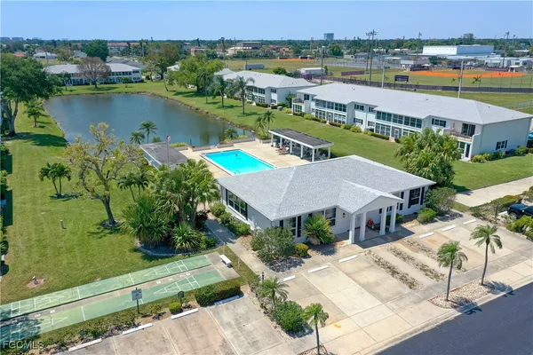an aerial view of a house with outdoor space and lake view