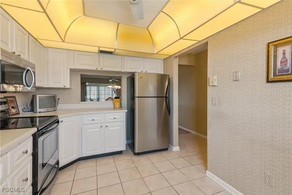 a kitchen with stainless steel appliances a refrigerator sink and cabinets
