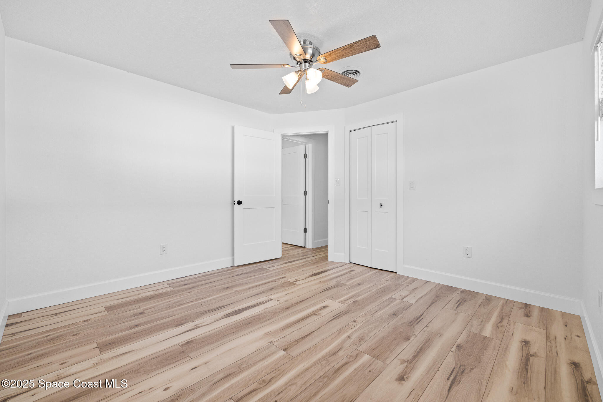 1988 Coolidge Avenue Melbourne, FL 32935 - Photo 12 of 18 wooden floor in an empty room