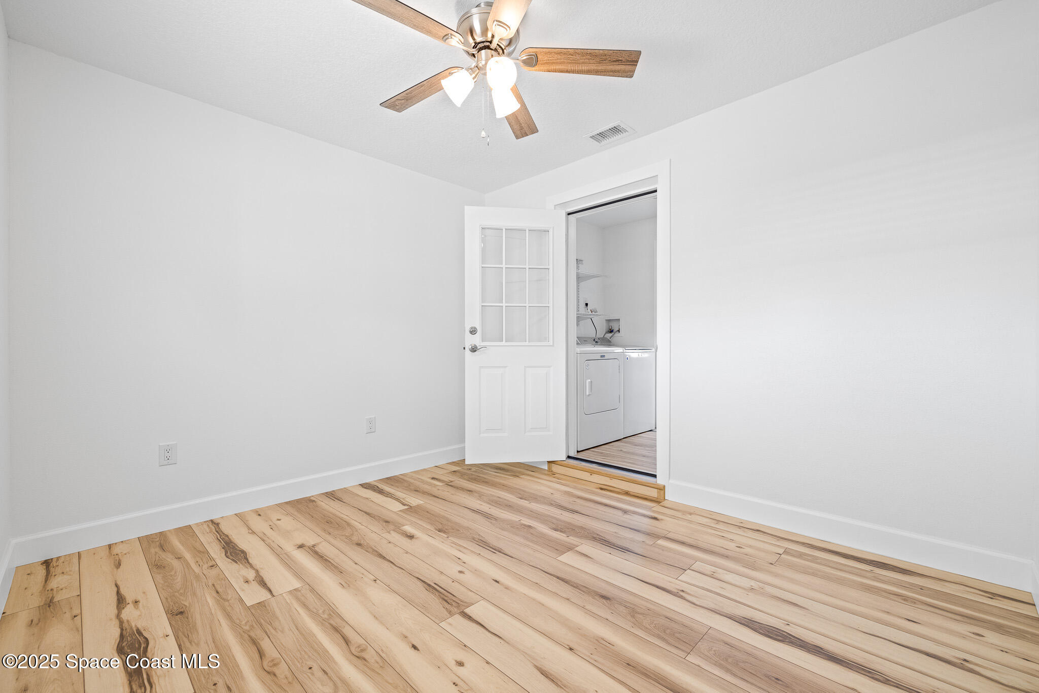 1988 Coolidge Avenue Melbourne, FL 32935 - Photo 15 of 18 a view of an empty room with wooden floor