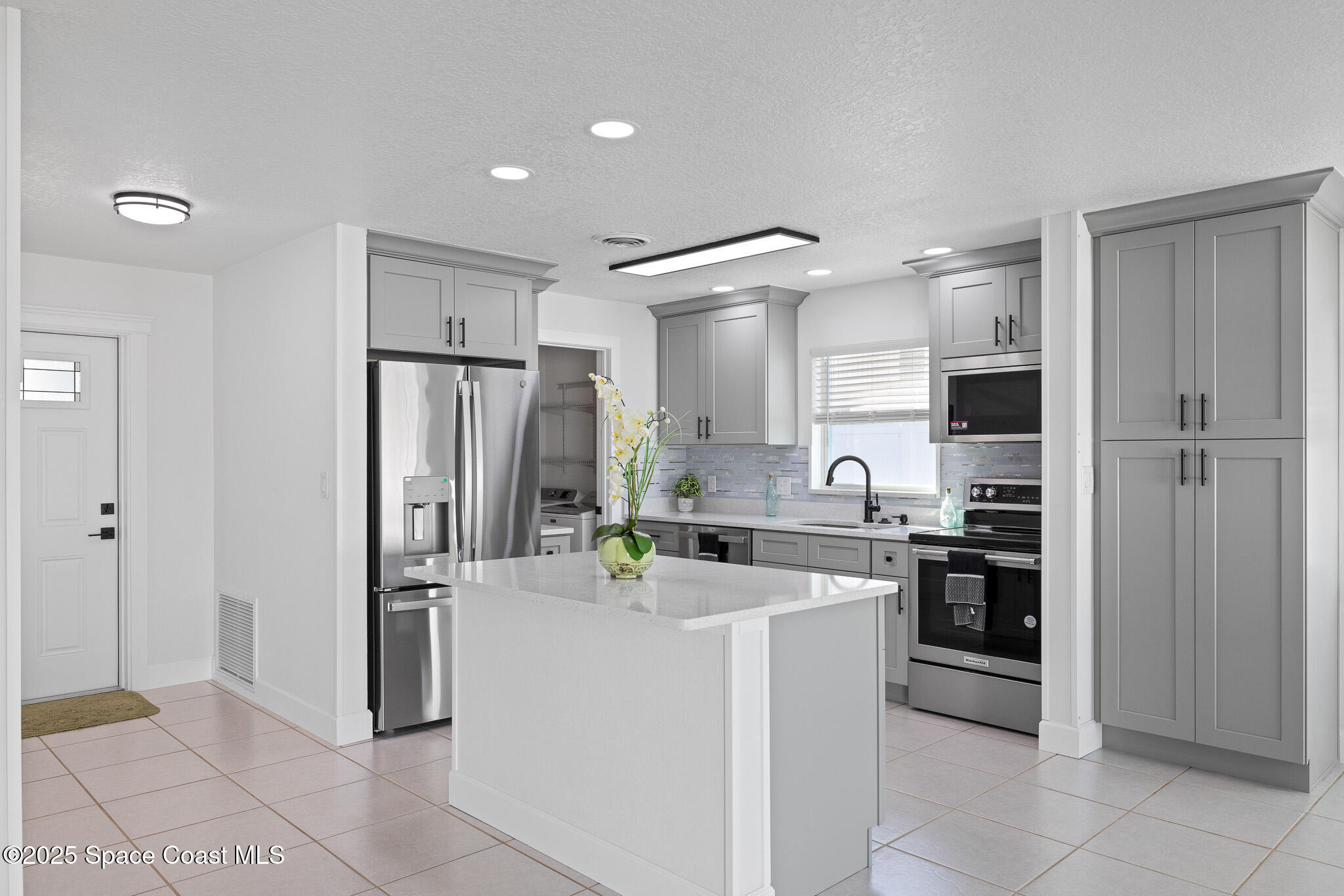 1988 Coolidge Avenue Melbourne, FL 32935 - Photo 2 of 18 a kitchen with refrigerator and cabinets