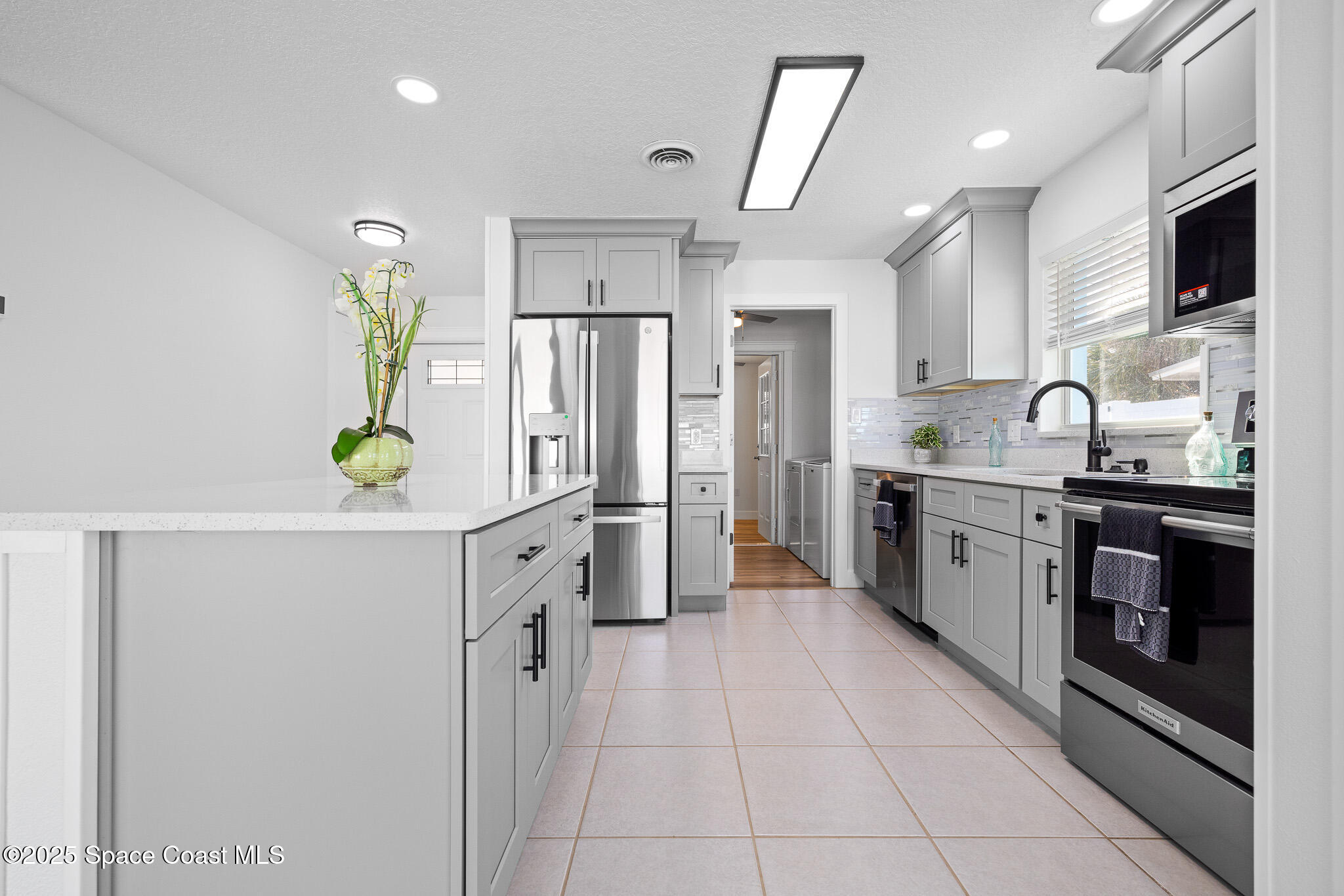 1988 Coolidge Avenue Melbourne, FL 32935 - Photo 3 of 18 a kitchen with a sink stainless steel appliances and cabinets