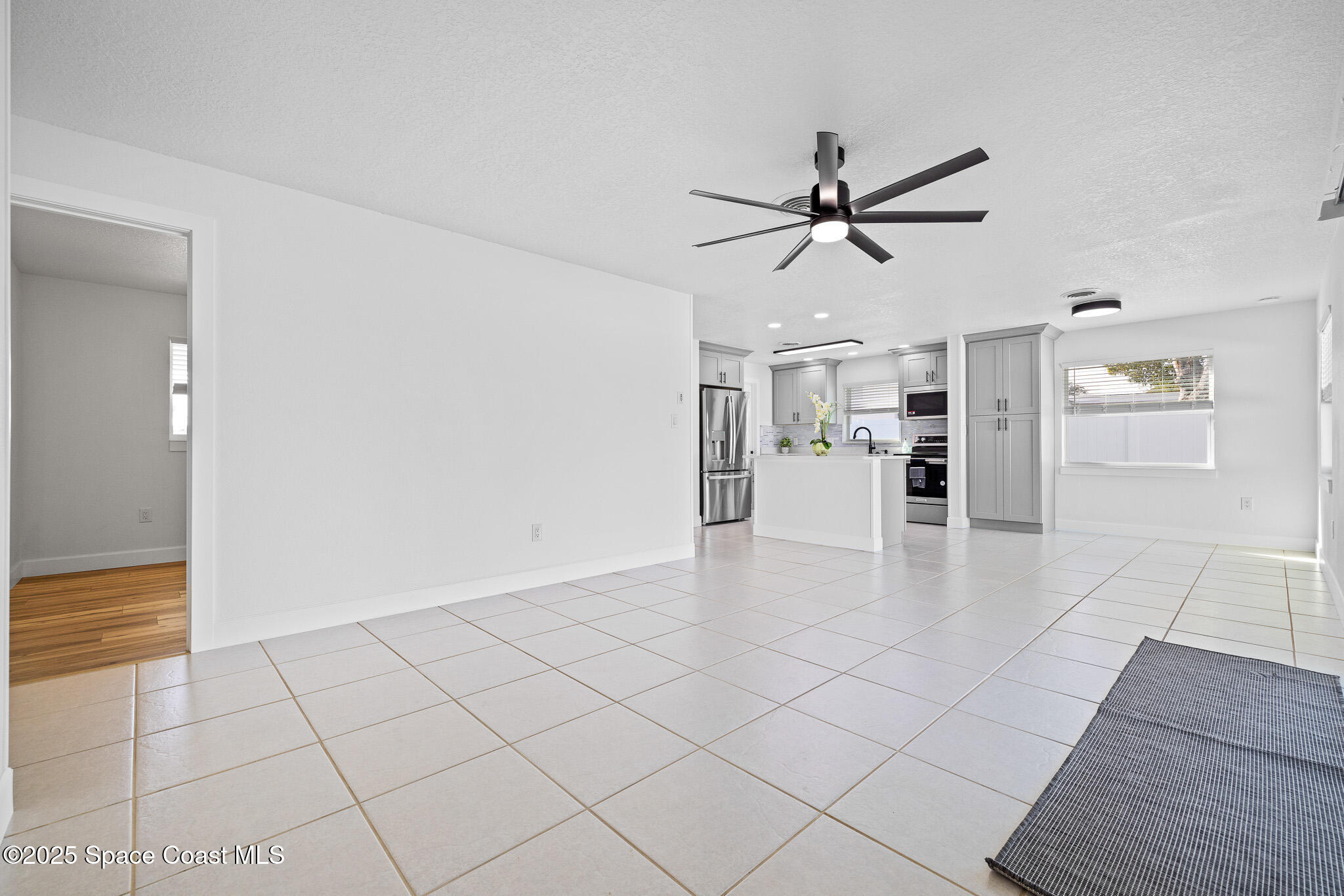 1988 Coolidge Avenue Melbourne, FL 32935 - Photo 5 of 18 a view of a livingroom with a ceiling fan and staircase