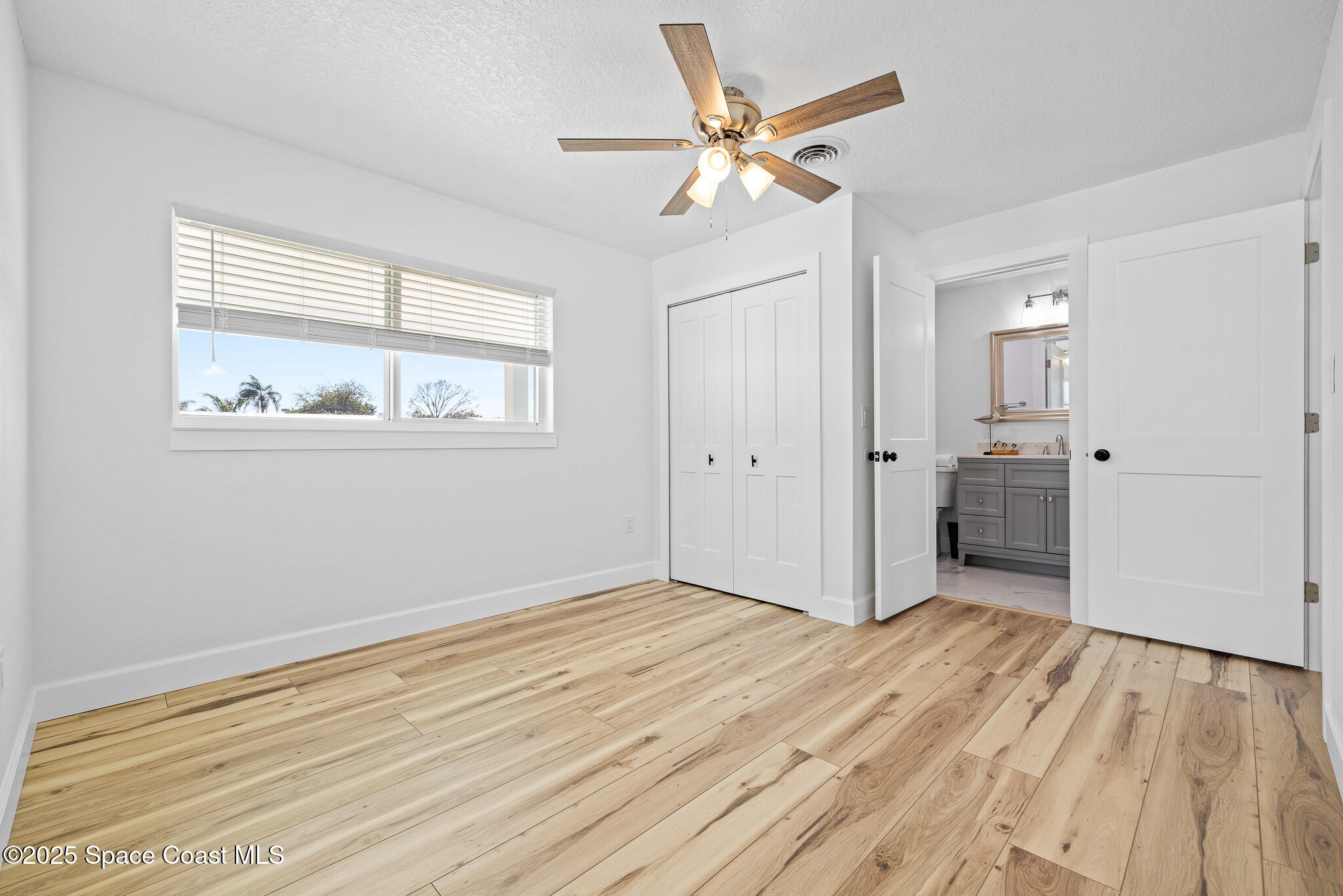 1988 Coolidge Avenue Melbourne, FL 32935 - Photo 6 of 18 wooden floor in an empty room with a window