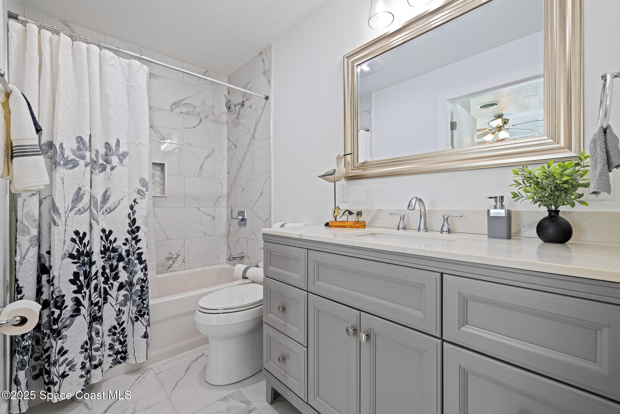 1988 Coolidge Avenue Melbourne, FL 32935 - Photo 7 of 18 a bathroom with a sink a toilet and a mirror