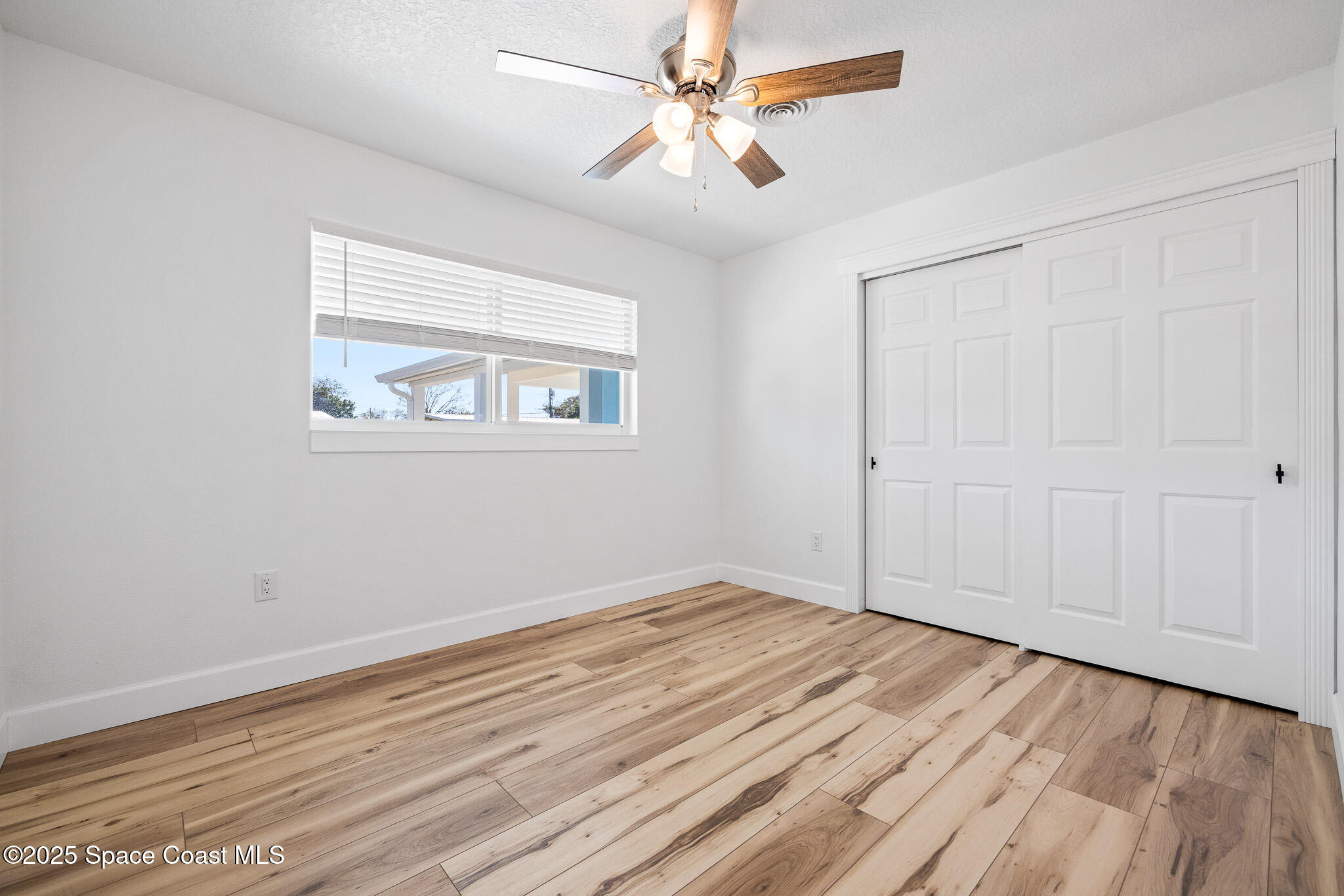 1988 Coolidge Avenue Melbourne, FL 32935 - Photo 8 of 18 wooden floor in an empty room with a window