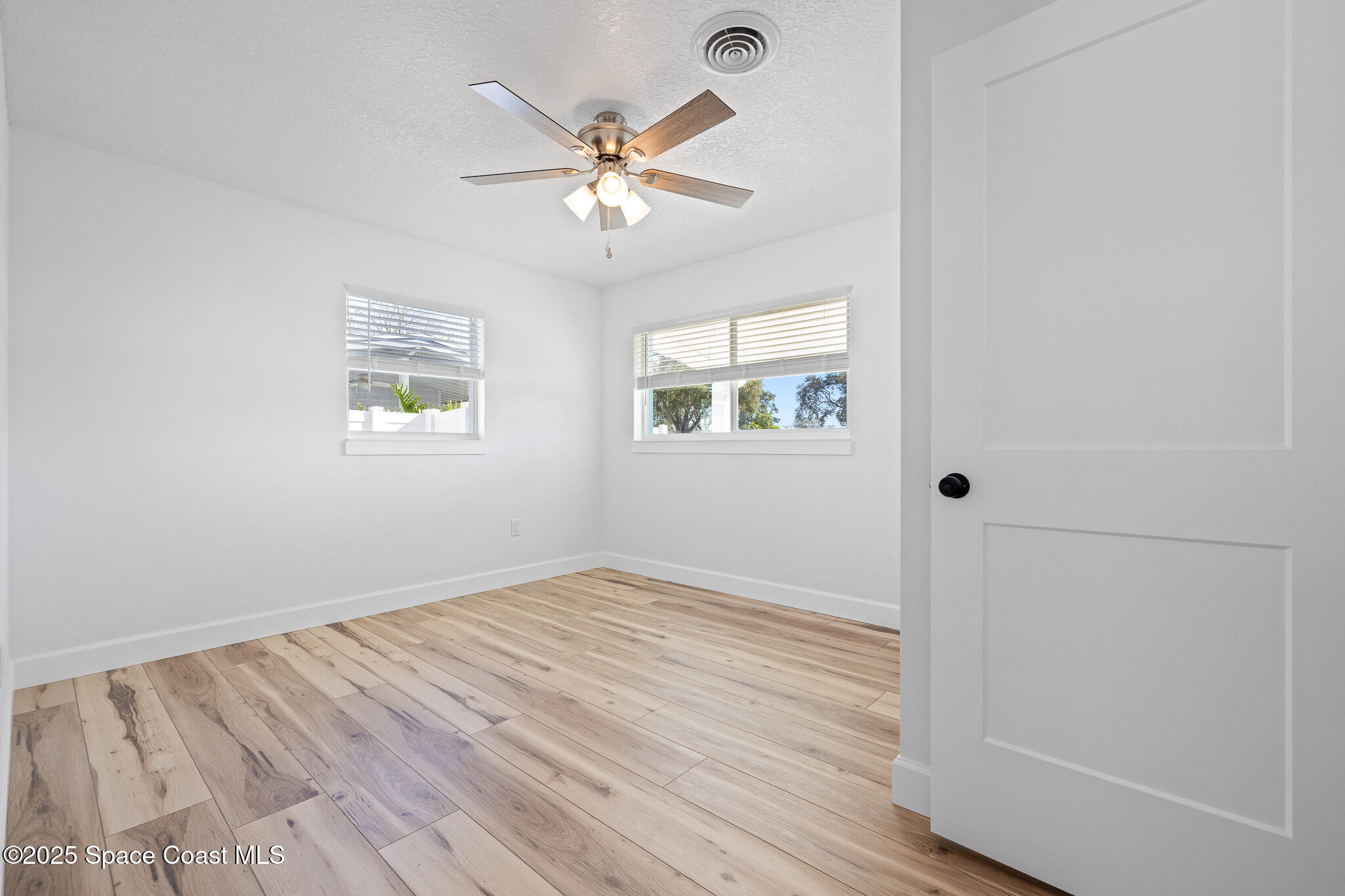 1988 Coolidge Avenue Melbourne, FL 32935 - Photo 10 of 18 wooden floor in an empty room with a window