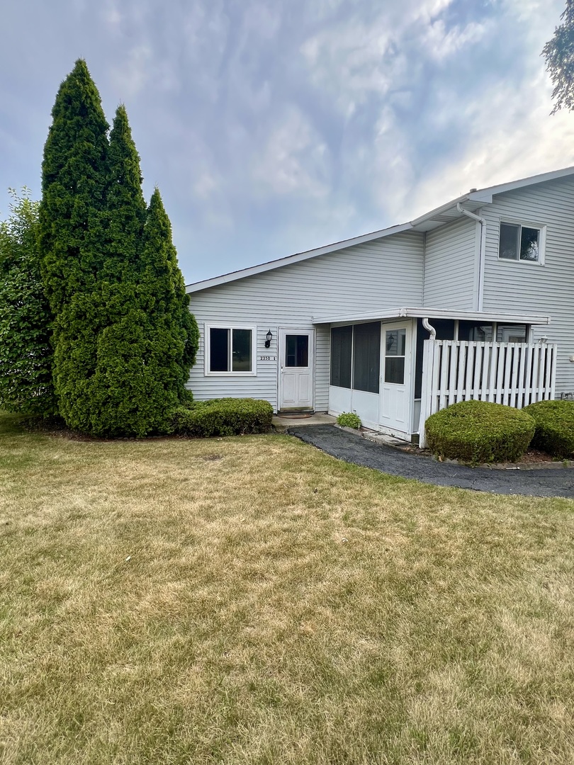 2350 Carnation Drive, Unit 4 Crest Hill, IL 60403 - Photo 1 of 19 a front view of a house with a yard