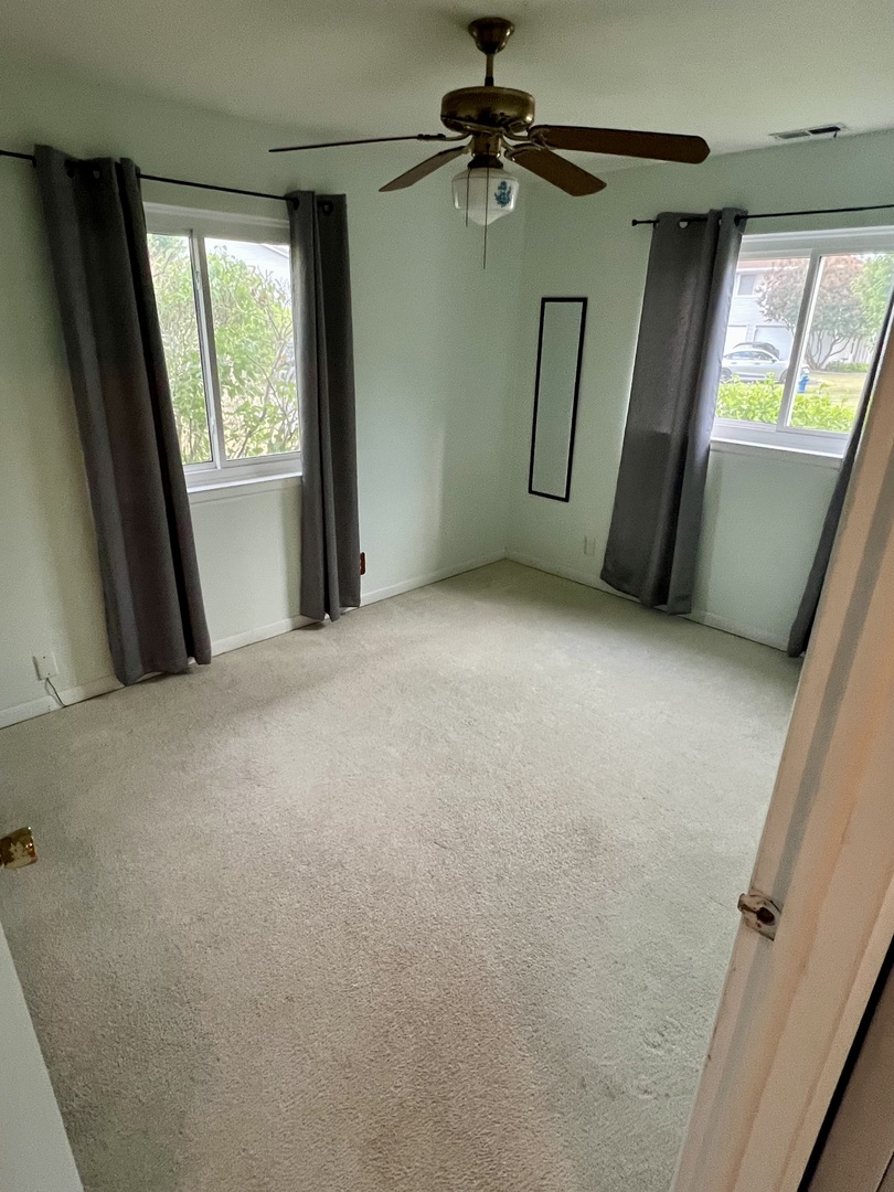 2350 Carnation Drive, Unit 4 Crest Hill, IL 60403 - Photo 7 of 19 a view of an empty room with a fireplace and a window