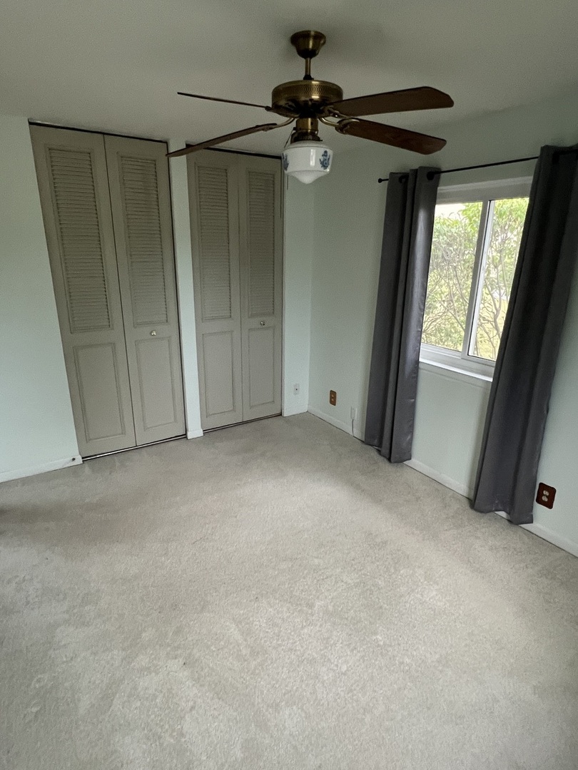 2350 Carnation Drive, Unit 4 Crest Hill, IL 60403 - Photo 8 of 19 a view of empty room with windows
