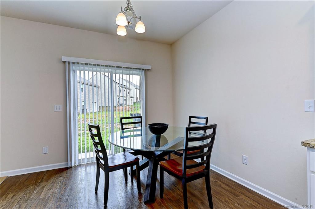 9537 Weikert Road Charlotte, NC 28215 - Photo 11 of 31 a view of a dining room with furniture wooden floor and chandelier