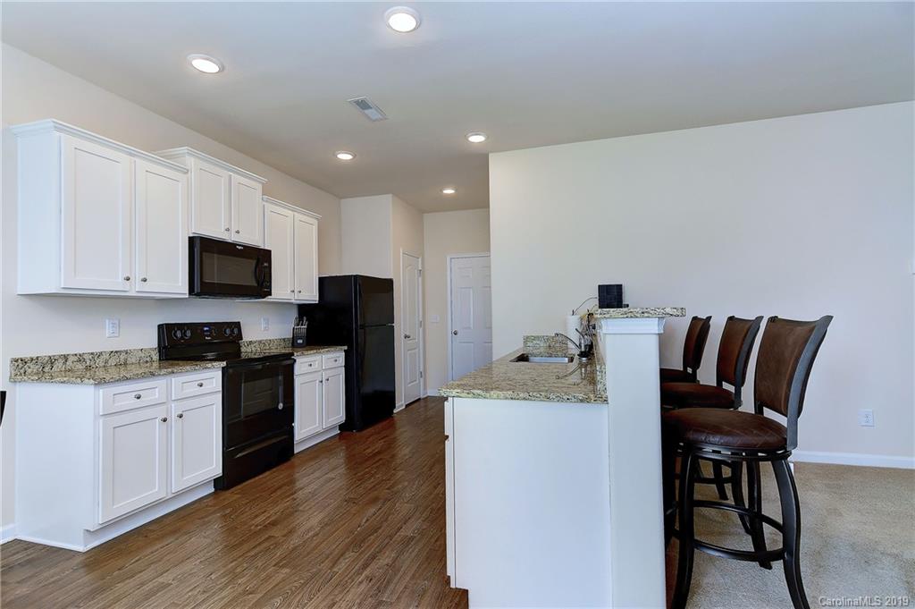 9537 Weikert Road Charlotte, NC 28215 - Photo 13 of 31 a kitchen with a stove a sink and a microwave
