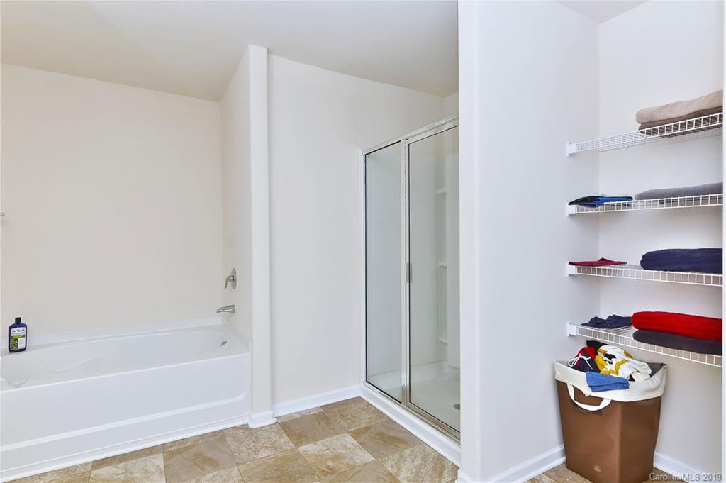 9537 Weikert Road Charlotte, NC 28215 - Photo 22 of 31 a bath room with a sink and wooden floor