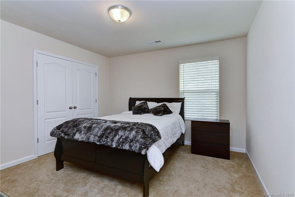 9537 Weikert Road Charlotte, NC 28215 - Photo 24 of 31 a bedroom with a bed and a window