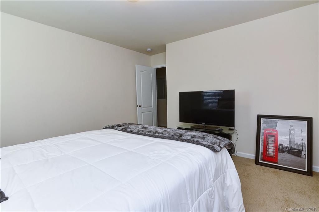 9537 Weikert Road Charlotte, NC 28215 - Photo 25 of 31 a bedroom with a bed and a flat screen tv
