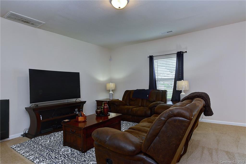 9537 Weikert Road Charlotte, NC 28215 - Photo 7 of 31 a living room with furniture and a flat screen tv