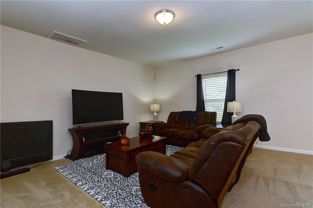 9537 Weikert Road Charlotte, NC 28215 - Photo 9 of 31 a living room with furniture and a flat screen tv