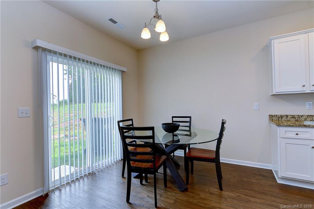 9537 Weikert Road Charlotte, NC 28215 - Photo 10 of 31 a view of a dining room with furniture window and wooden floor