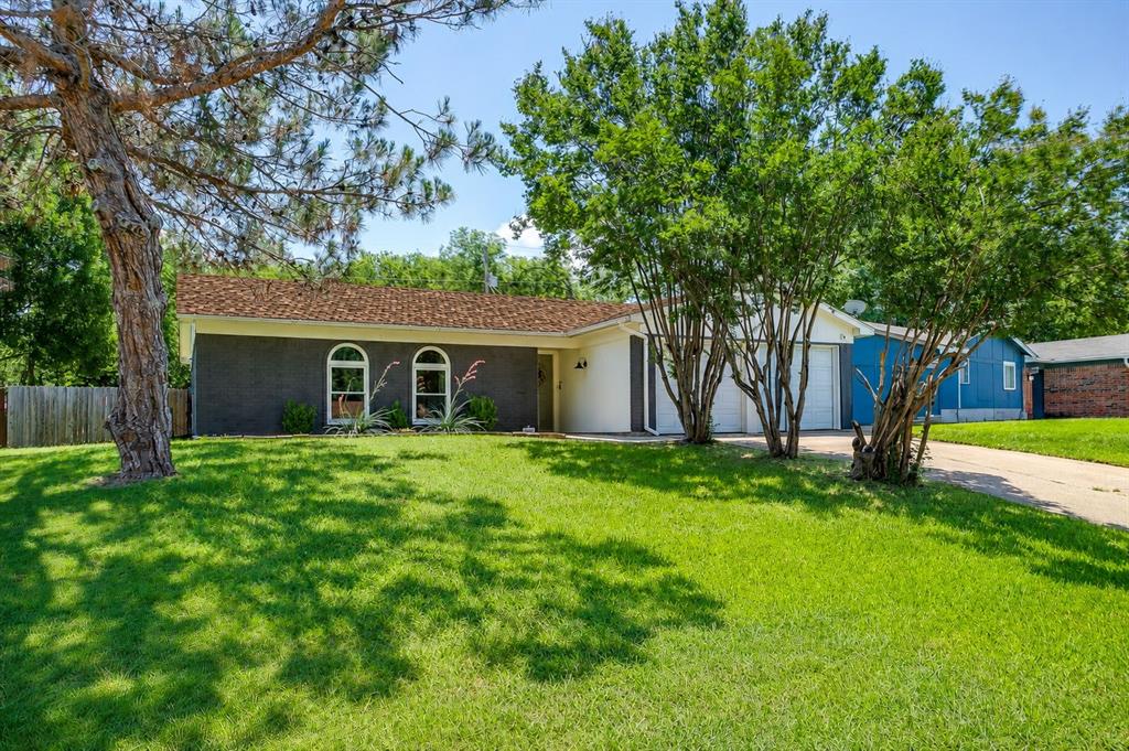 712 Poe Street Azle, TX 76020 - Photo 5 of 35 a view of a house with a backyard and a tree
