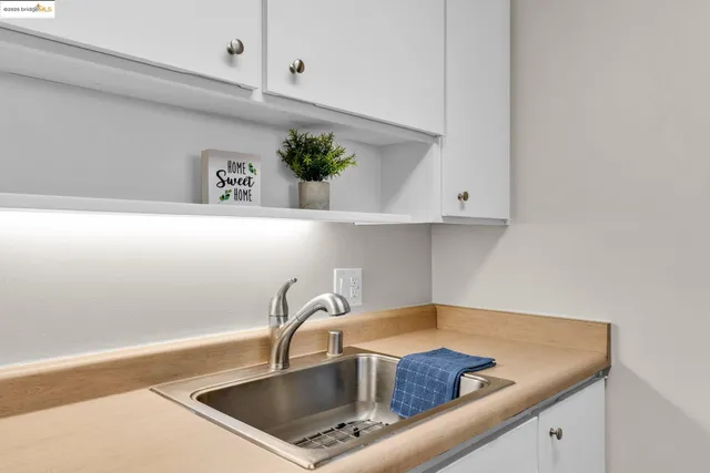 a kitchen with a sink a counter and cabinets