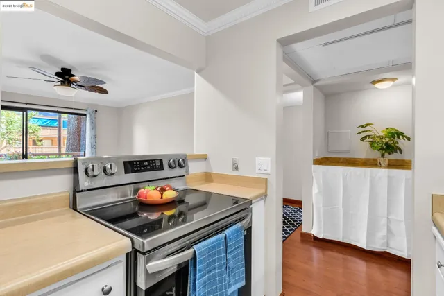 a kitchen with stainless steel appliances cabinets and wooden floor